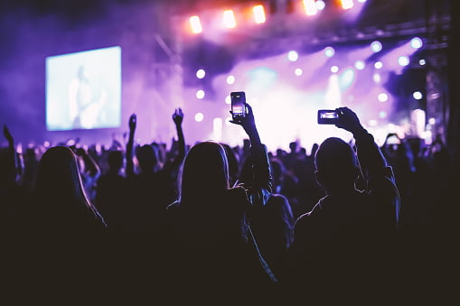 People holding their smart phones and photographing concert